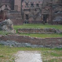 Baths of Caracalla - View of the Baths of Caracalla with a low brick wall in the foreground