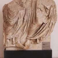 Marble Relief Fragment  - View of a marble fragment of two striding togate figures
