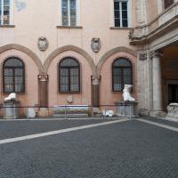 Capitoline Museums - Interior: Row of fragments from the colossal statue of Costantine and 15th century archways along righthand wall of the courtyard of Palazzo dei Conservatori