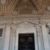 Saint Peter's Basilica - Exterior: View of a Door in the Portico of Saint Peter's Basilica looking towards Saint Hyginus I and Saint Pius I