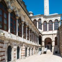 Laleli Camii - Exterior: Complex Courtyard, VIew of Northeast Arcade form Southeast, Arched Side Entrance