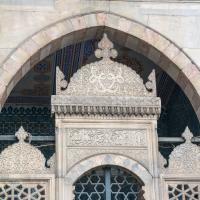 Yeni Camii - Exterior: Northeastern Facade Detail, Engraved Ornamental Grill; Inscription; Polychrome Marble