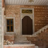 Beylerbeyi Camii - Exterior: Northeast Portico, Facing Southwest, Northeast Entrance, Quranic Inscription on String Course