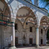 Cerrah Mehmed Pasha Camii - Exterior: Northwest Portico, Arcade, Facing South, Muqarnas Column Capitals, Ablaq Detail on Pointed Arches